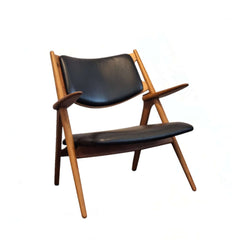 Sawbuck Lounge Chair Black Leather seat and backrest in teak natural finish