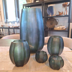 Seafog Tealight Holder 9cm, Seafog Vase 17cm, Seafog Vase 41cm in soft blue-grey-green frosted glass, its smooth vertical panels and opalescent finish giving it a quiet, luminous quality like light diffused through coastal mist.