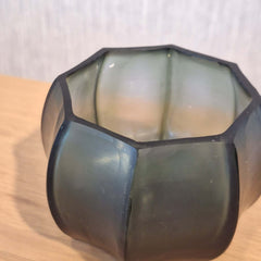 Seafog Tealight Holder 7cm in blue-grey-green frosted glass, its soft vertical panels glowing with a cool, watery light when a flame burns gently inside.