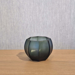 Seafog Tealight Holder 7cm in blue-grey-green frosted glass, its soft vertical panels glowing with a cool, watery light when a flame burns gently inside.