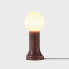 Shore Table Lamp Bottle Brown with a mouth-blown bottle brown glass base and a matte white bulb, featuring an in-line dimmer, by Tala