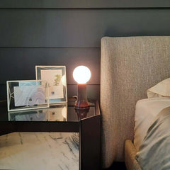 Shore Table Lamp Bottle Brown with a mouth-blown bottle brown glass base and a matte white bulb, featuring an in-line dimmer, by Tala