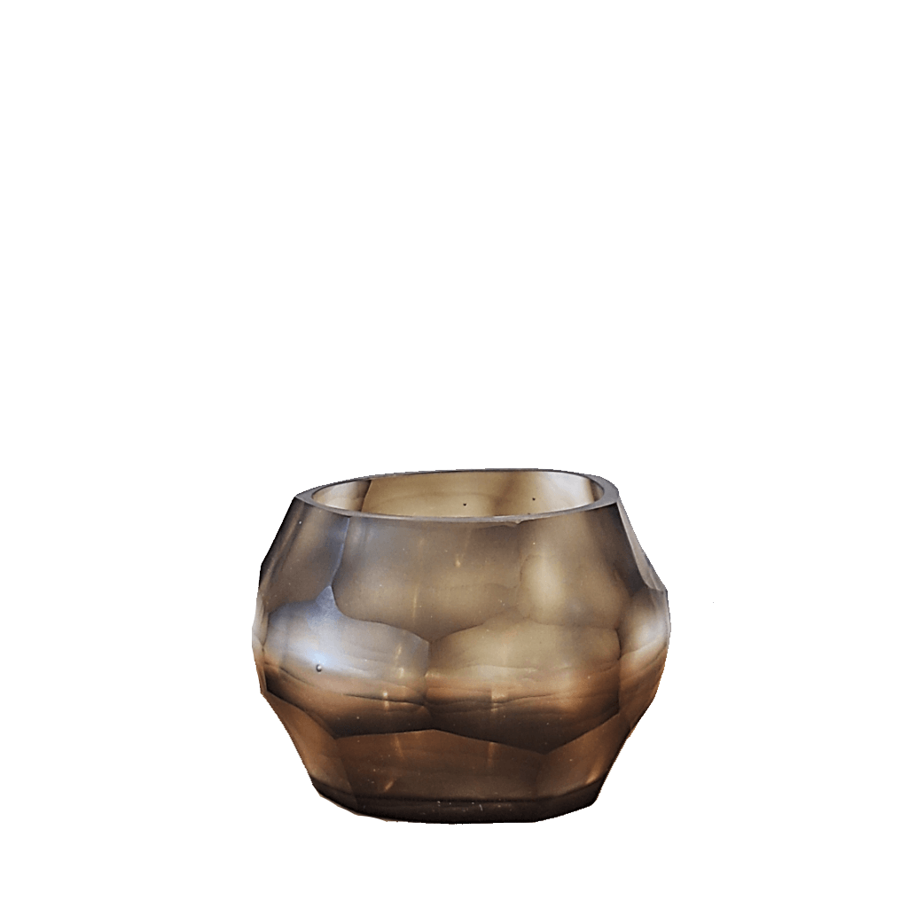 Sunhive Tealight Holder 8cm in warm smoky taupe frosted glass, its compact form wrapped in angular faceted cells that catch and hold the light with a quiet, burnished warmth.