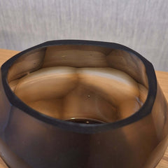 Sunhive Tealight Holder 8cm in warm smoky taupe frosted glass, its compact form wrapped in angular faceted cells that catch and hold the light with a quiet, burnished warmth.