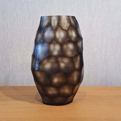 Sunhive Vase 33cm in warm smoky taupe frosted glass, its surface covered in large rounded organic cells that ripple upward like honeycomb lit from within.