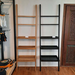A solid wood display stand, featuring a simple, elegant design with three levels of shelves, to be leaned against the wall