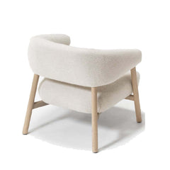 A lounge chair with a light wood base and off-white fabric upholstery.