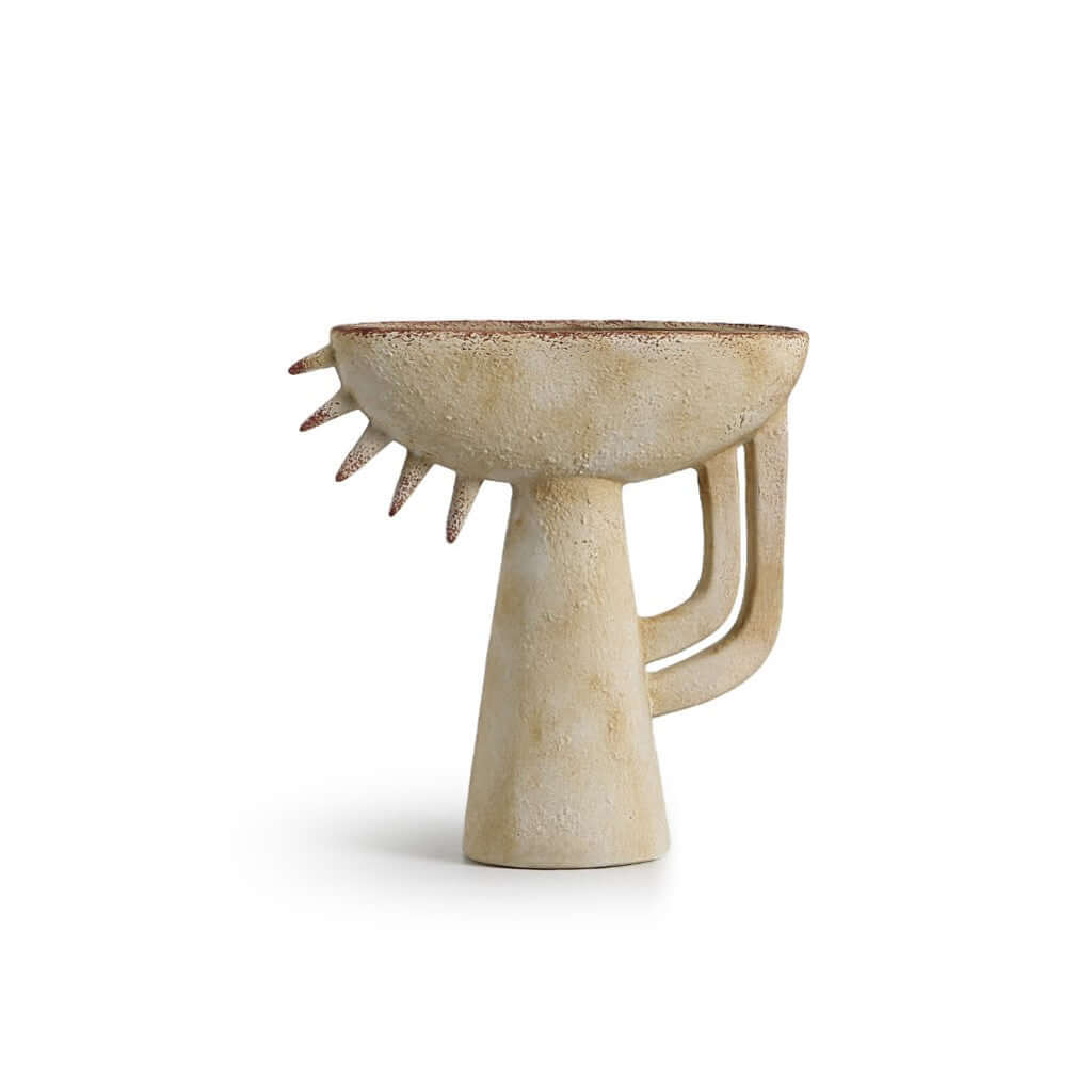 A ceramic Theodore Vase Beige with an abstract and unique shape, featuring a small handle on the side.