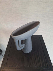 A black ceramic vase A ceramic Theodore Vase Black with an abstract and geometric shapean abstract and geometric shape