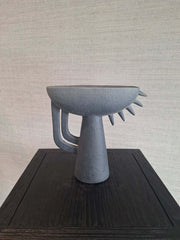 A ceramic Theodore Vase Black with an abstract and geometric shape
