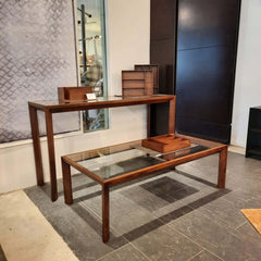 A modern and elegant tables with a solid walnut natural finish and a 6mm tempered glass tabletop.