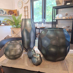 Tundra Tealight Holder 9cm, Tundra Vase 18cm, Tundra Vase 32cm, Tundra Vase 41cm in cool silver-grey frosted glass, with sharp geometric facets running its full height — sculptural and commanding as a statement piece.