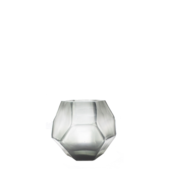 Tundra Tealight Holder 9cm in cool silver-grey frosted glass, its geometric facets casting a soft, fractured glow when lit from within.