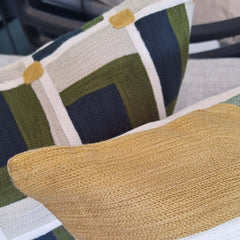 Verec Embroidered Cushion 45x45cm showcasing vibrant patterns in green, navy, and yellow hues on a cozy textured fabric.