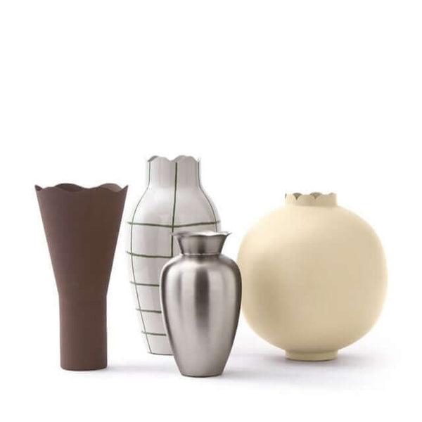 A set of four vases with wavy tops in different colors and materials. From left to right: enamel painted with hand painted pattern, powder coated rough texture, powder coated rough texture, and brushed stainless steel. By Pols Potten