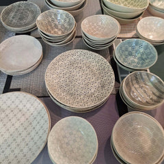 Collection of ceramic plates and bowls with various patterns and colours, by Wonki Ware