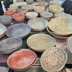 Collection of ceramic plates and bowls with various patterns and colours, by Wonki Ware