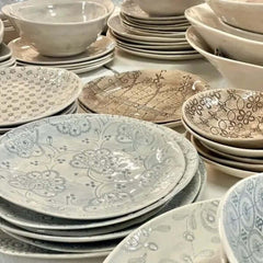 Collection of ceramic plates and bowls with various patterns, by Wonki Ware