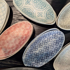 Collection of oval shaped Pebble Olive Dishes with decorative patterns, by Wonki Ware