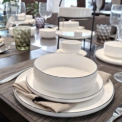 A white fine bone china Oco dinnerware with a hand-painted black line design around the edge, by ASA selection