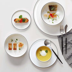 A white fine bone china Oco dinnerware with a hand-painted black line design around the edge, by ASA selection