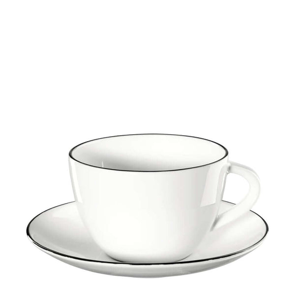 A white ceramic coffee cup with a saucer, featuring hand-painted black lines around the cup's edge, by ASA selection