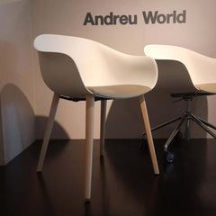 Next Chair Beech Legs featuring solid beech legs and grey leather seat cushion on white thermo-polymer seat.