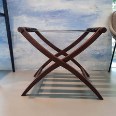 A solid walnut luggage rack with heavy duty nylon straps, foldable design.