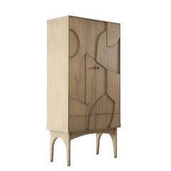 A simple bookcase with abstract patterns on the front doors, made of wood and finished in a new beech colour, with round brass door handles.