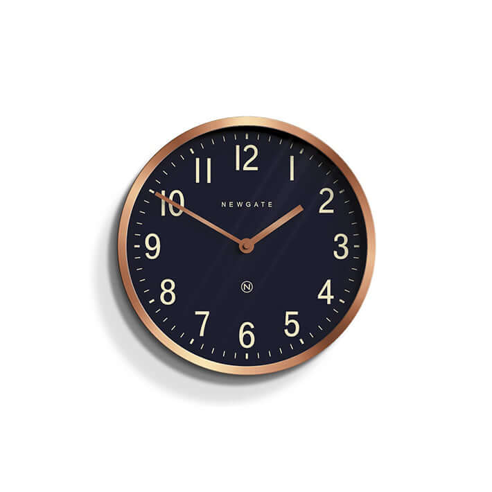 Newgate Master Edwards Wall Clock Copper with a copper colored metal case and a black dial with metal hands and Arabic numerals.
