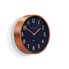 Newgate Master Edwards Wall Clock Copper with a copper colored metal case and a black dial with metal hands and Arabic numerals.