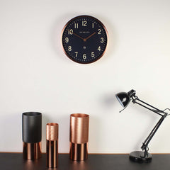 Newgate Master Edwards Wall Clock Copper on a wall
