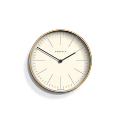 Newgate Mr Clarke Wall Clock Pale Wood with a linear marker dial, metal hands, and a glass lens.