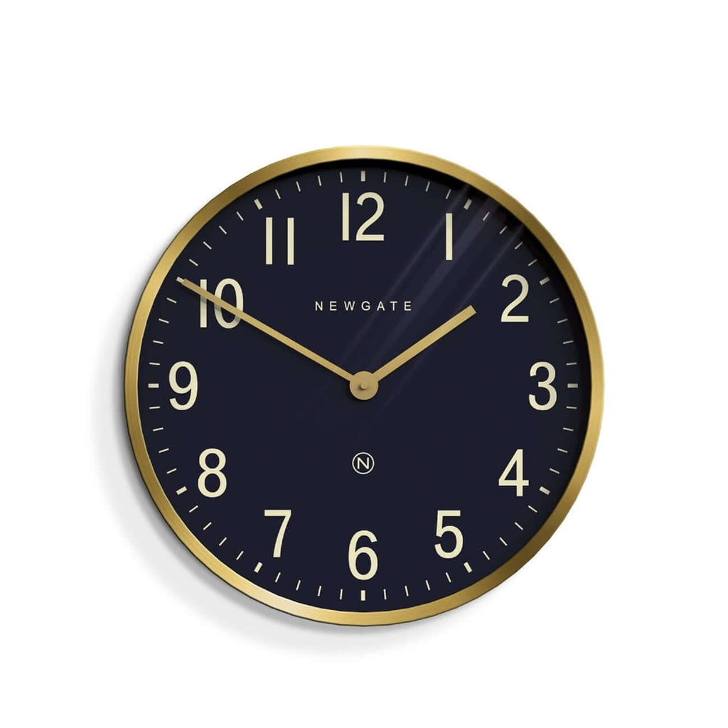 Newgate Mr Edwards Wall Clock Brass with a black background, gold numbers, and a gold metal case.