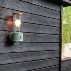 The Muse Wall Light Pleasure Garden Green, featuring solid brass detailing and an integrated dimmer switch.