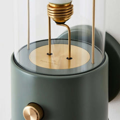 The Muse Wall Light Pleasure Garden Green, featuring solid brass detailing and an integrated dimmer switch.