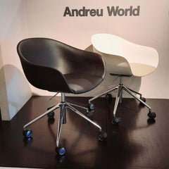 Next Swivel Chair Black featuring swivel base on casters and upholstered seat in black leather.