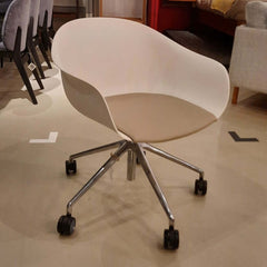 Next Swivel Chair White featuring swivel base on casters and grey leather seat cushion on white thermo-polymer seat.