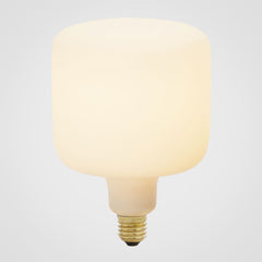 An oblong-shaped LED bulb with a matte glass finish, emitting a soft white light, designed to screw into an Edison-style base, by Tala