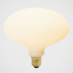 An oval-shaped LED bulb with a matte glass finish, emitting a soft white light, designed to screw into an Edison-style base, by Tala