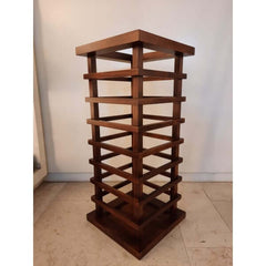 A solid walnut umbrella stand with a decorative ladder-like structure