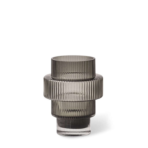 A conical grey-colored glass candle holder with vertical ridges, featuring an intricate and textured design, by Pols Potten