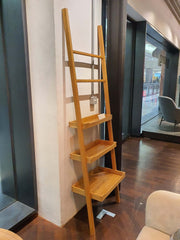 A solid wood display stand with a natural oak finish, featuring a simple, elegant design with three levels of shelves, to be leaned against the wall