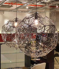 A modern pendant ceiling light with a copper finish and a visible integrated LED module, creating a melting hot-blown glass effect, by Tom Dixon