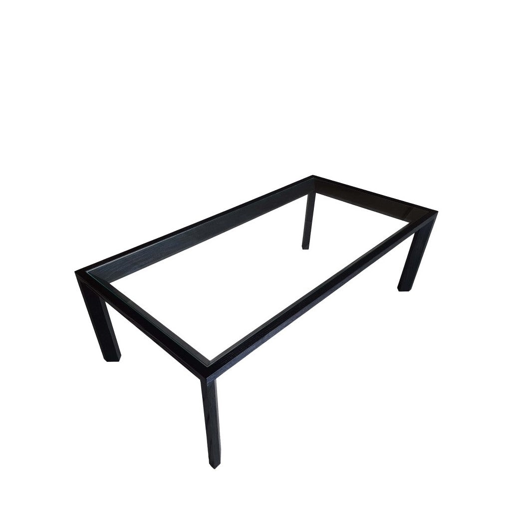 A modern and elegant coffee table with a mitre joint design, made of solid ash wood with a charcoal finish and a 6mm tempered glass top.
