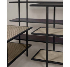 A black powder coated steel Yombe Console with three shelves, featuring a slatted wood pattern on the shelves. 